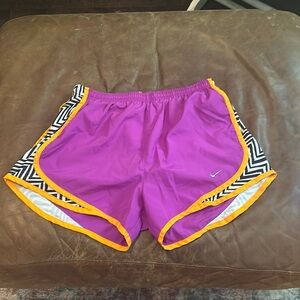 Nike athletic shorts size Small. Pink, orange, and black and white accents.